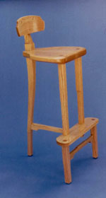 A bar stool in red oak